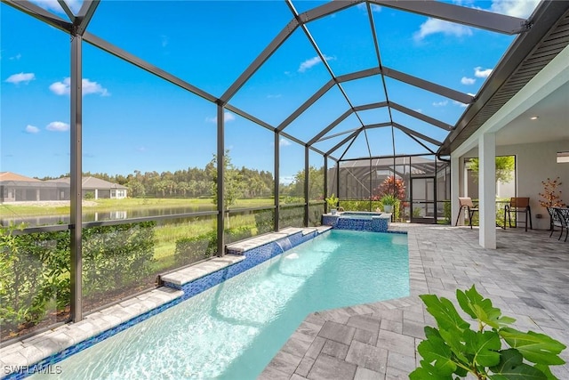 view of swimming pool with a patio area, glass enclosure, a water view, and a pool with connected hot tub