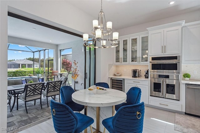 dining area with recessed lighting, beverage cooler, a notable chandelier, and light tile patterned floors