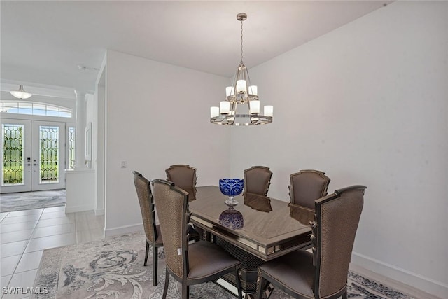 dining area with french doors, decorative columns, light tile patterned floors, a chandelier, and baseboards