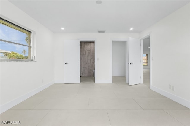 unfurnished bedroom featuring light tile patterned flooring