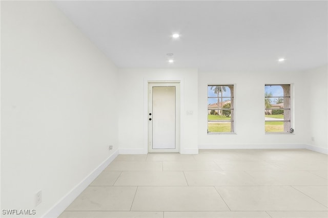 spare room featuring light tile patterned flooring