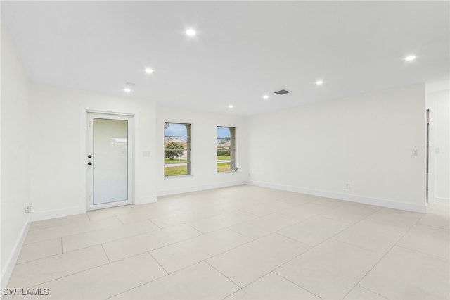 spare room featuring light tile patterned flooring