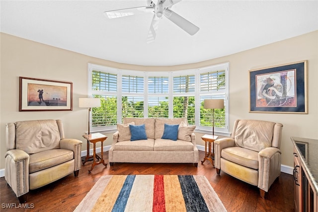 living room featuring ceiling fan and dark hardwood / wood-style flooring