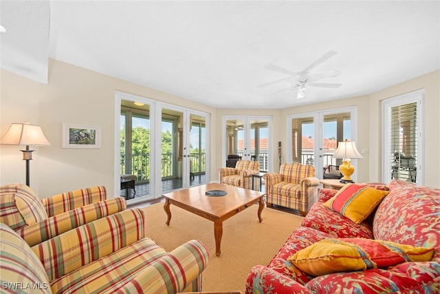 living room featuring french doors, ceiling fan, and carpet flooring