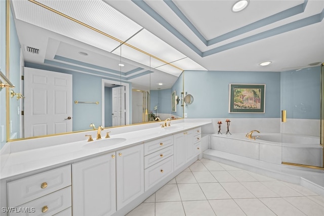 bathroom featuring tile patterned flooring, a raised ceiling, independent shower and bath, and vanity