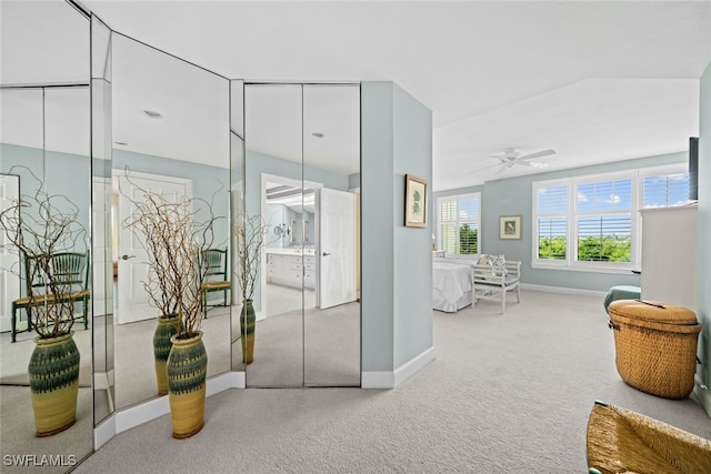 interior space with vaulted ceiling and carpet flooring