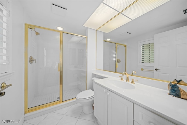 bathroom featuring vanity, toilet, an enclosed shower, and tile patterned flooring