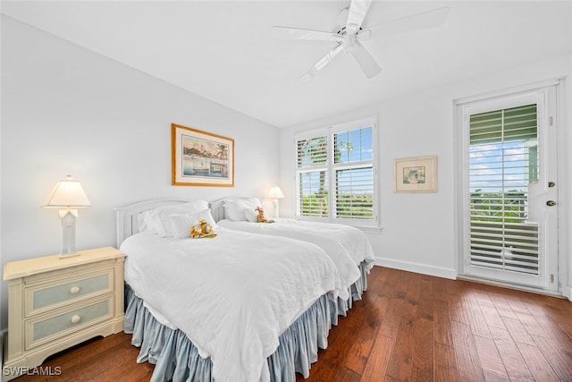 bedroom with dark wood-type flooring, multiple windows, and ceiling fan