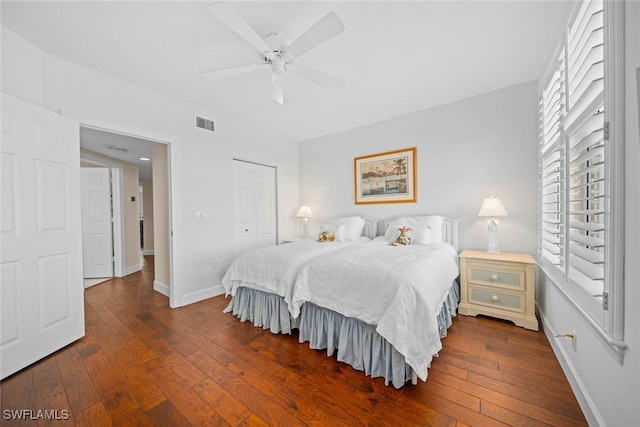 bedroom with a closet, ceiling fan, and dark hardwood / wood-style flooring