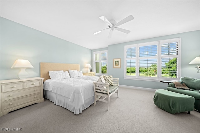 carpeted bedroom with vaulted ceiling and ceiling fan