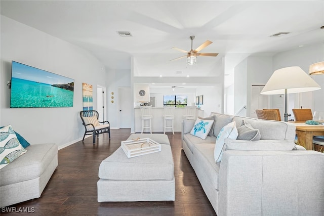 living room with ceiling fan and dark hardwood / wood-style flooring