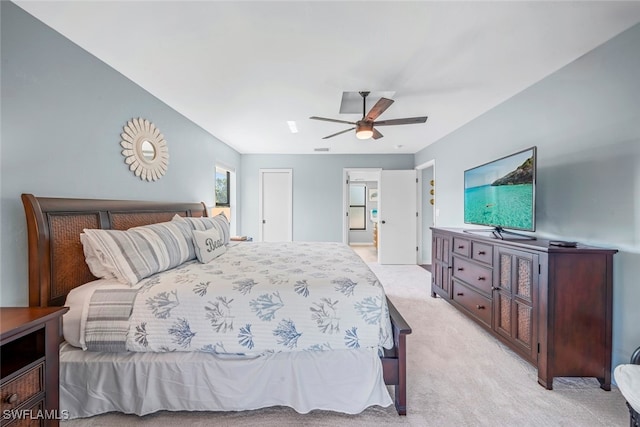 bedroom featuring ceiling fan and light carpet