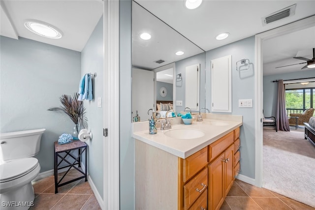 bathroom with ceiling fan, vanity, tile patterned flooring, and toilet