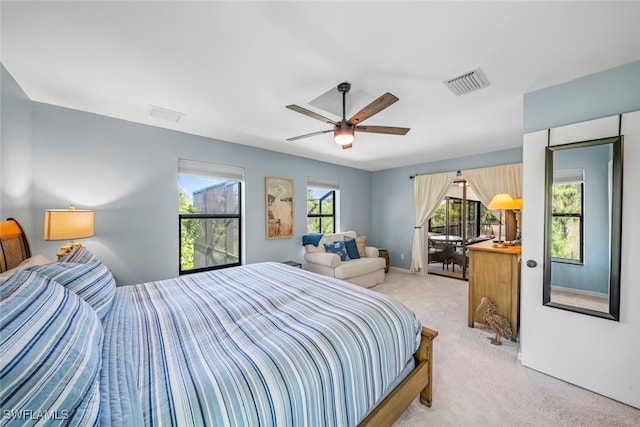 carpeted bedroom featuring ceiling fan and multiple windows