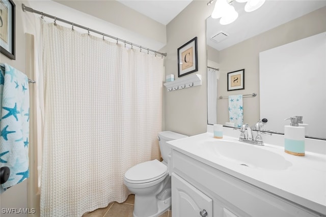 bathroom with a shower with curtain, vanity, toilet, and tile patterned floors