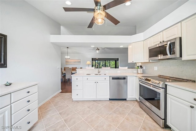 1610 Sabal Sands Rd, Sanibel, FL 33957 - kitchen with a sink, stainless steel appliances, ceiling fan, light countertops, and light tile patterned floors