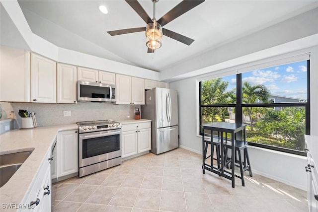 1610 Sabal Sands Rd, Sanibel, FL 33957 - kitchen with a ceiling fan, decorative backsplash, stainless steel appliances, and lofted ceiling