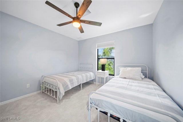 bedroom with light carpet and ceiling fan