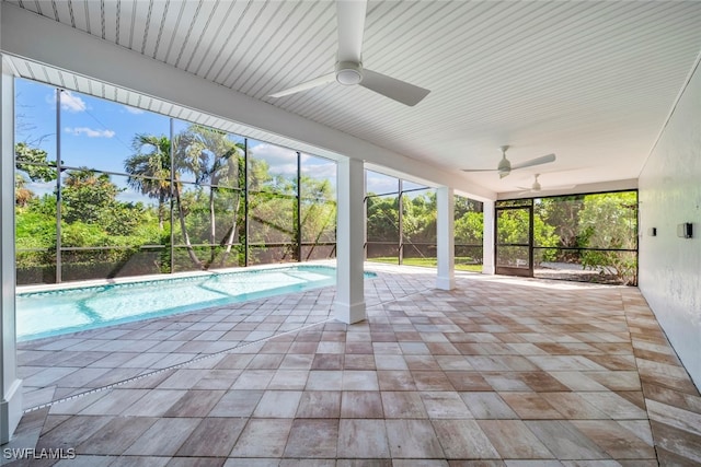 view of pool with glass enclosure, ceiling fan, and a patio area