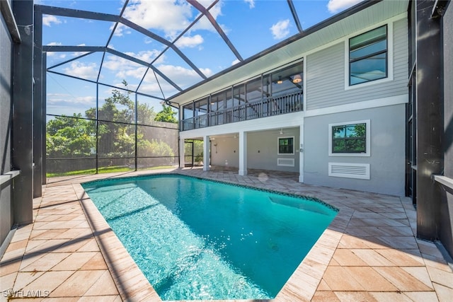 view of swimming pool featuring a lanai and a patio