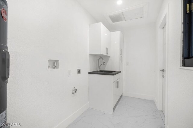 clothes washing area with marble finish floor, a sink, electric dryer hookup, and baseboards