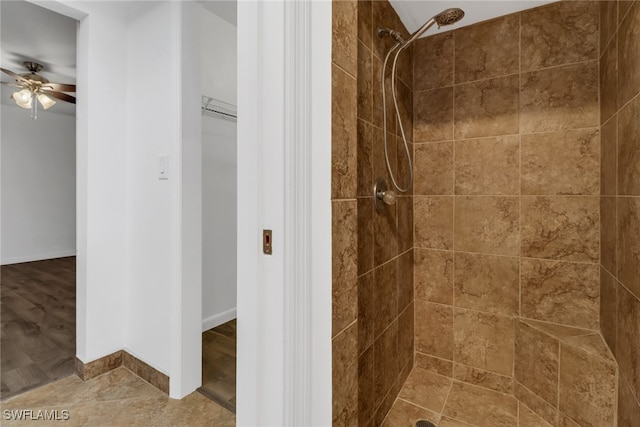 bathroom featuring tiled shower, ceiling fan, and hardwood / wood-style flooring