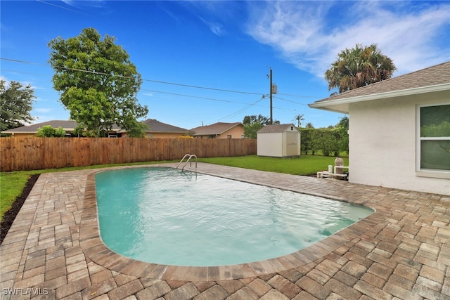 view of pool featuring a storage shed, a yard, and a patio