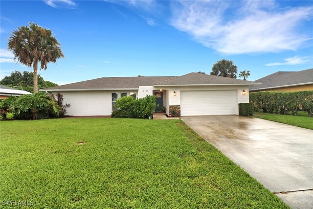 ranch-style home with a front yard and a garage