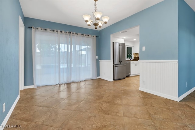 empty room featuring a chandelier and sink