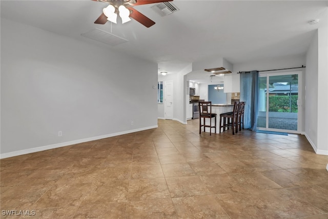 unfurnished living room with ceiling fan