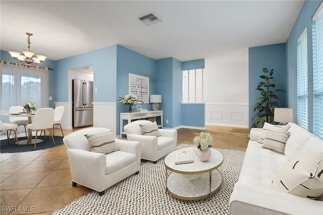 tiled living room featuring a chandelier