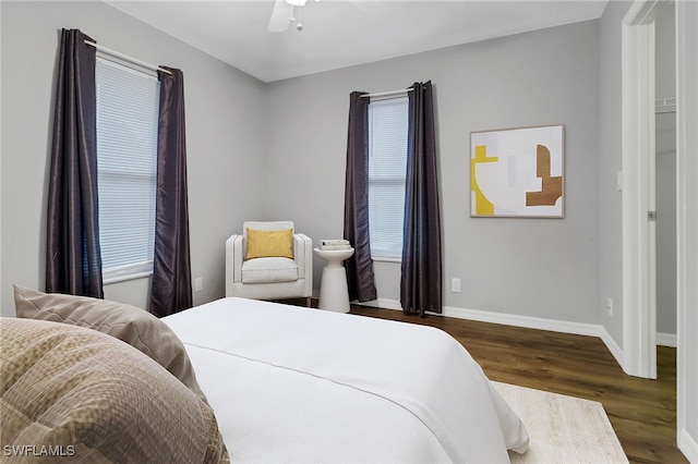 bedroom with dark hardwood / wood-style floors and ceiling fan