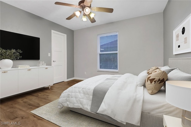 bedroom with dark wood-type flooring and ceiling fan