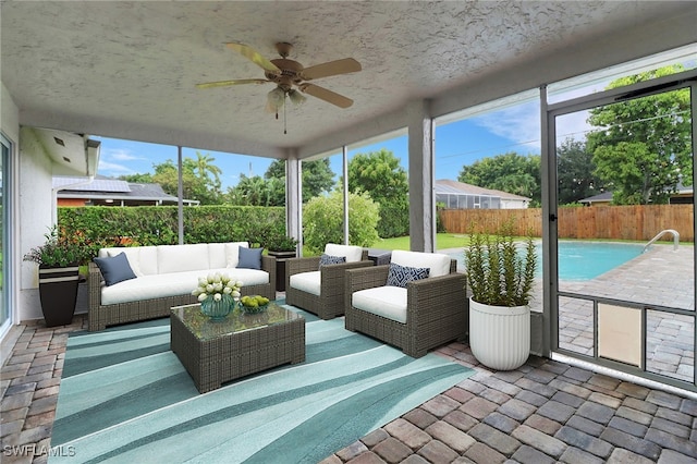 sunroom / solarium with plenty of natural light and ceiling fan