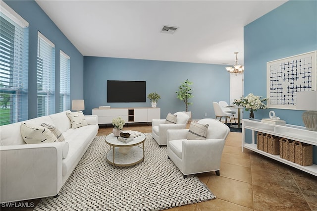 living room featuring an inviting chandelier and tile patterned flooring