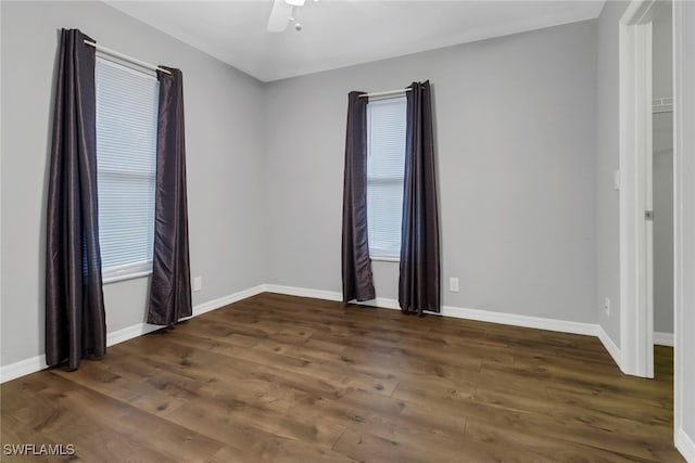 unfurnished room with dark hardwood / wood-style floors and ceiling fan