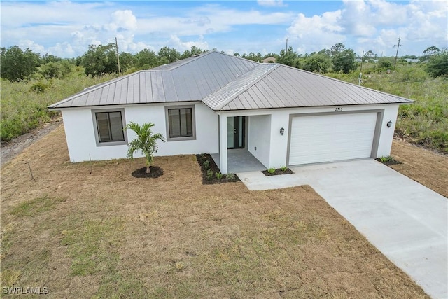 516 Kilarney Ave S, Lehigh Acres, FL 33974 - view of front of house with a garage, driveway, metal roof, and stucco siding