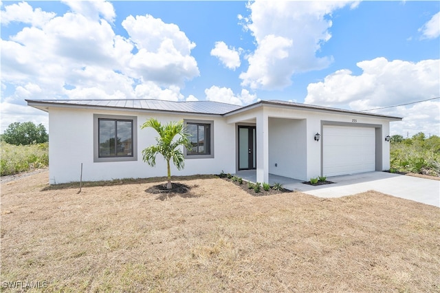 single story home featuring a front yard and a garage