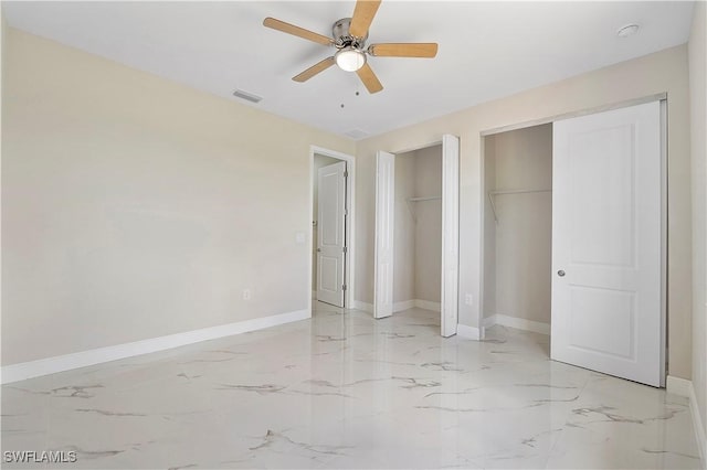 516 Kilarney Ave S, Lehigh Acres, FL 33974 - unfurnished bedroom with two closets, baseboards, visible vents, and marble finish floor