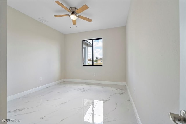 516 Kilarney Ave S, Lehigh Acres, FL 33974 - empty room with baseboards, visible vents, ceiling fan, and marble finish floor