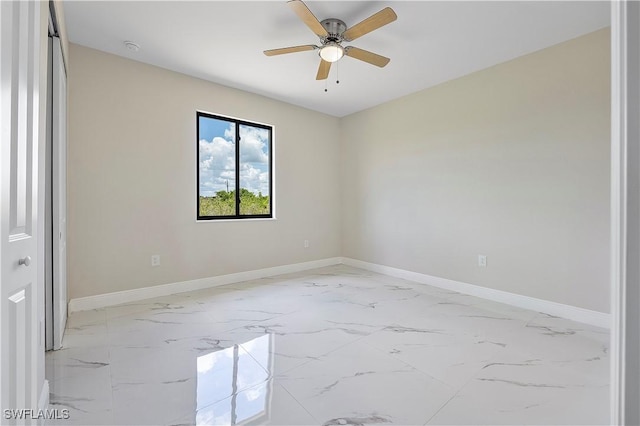 516 Kilarney Ave S, Lehigh Acres, FL 33974 - spare room featuring a ceiling fan, baseboards, and marble finish floor