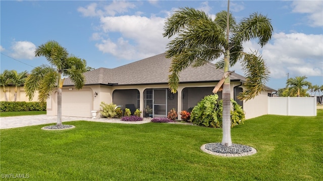 view of front of house featuring a garage and a front lawn