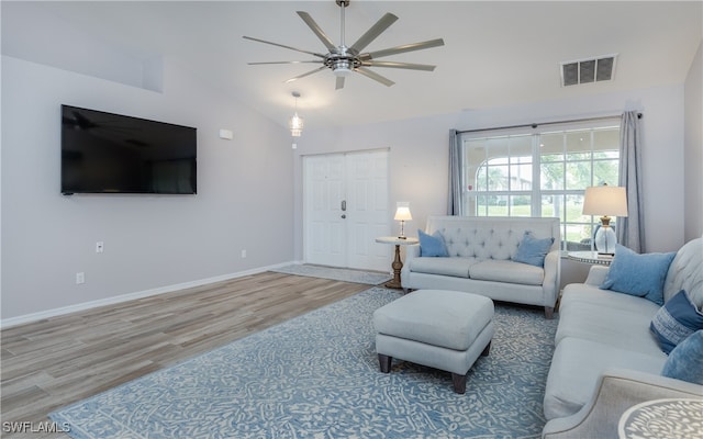 living room with lofted ceiling, ceiling fan, and wood-type flooring