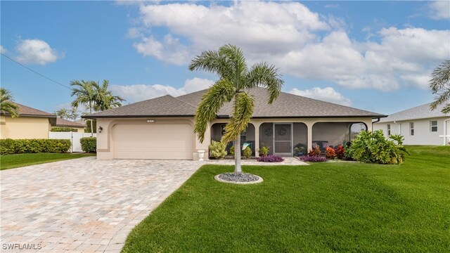 ranch-style house featuring a garage, a front yard, and a sunroom