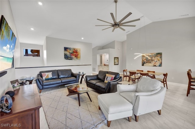 living room with ceiling fan and vaulted ceiling