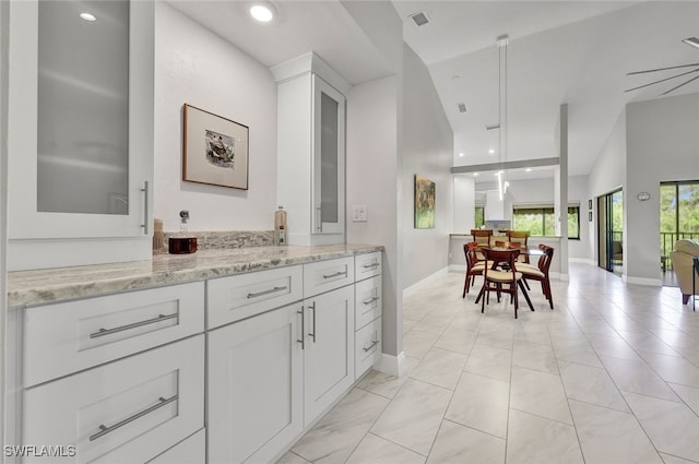 bathroom with vanity, ceiling fan, and lofted ceiling