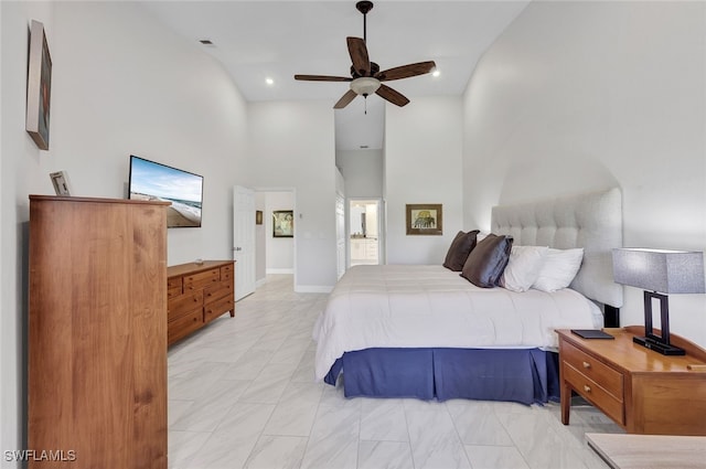 bedroom featuring connected bathroom, high vaulted ceiling, and ceiling fan