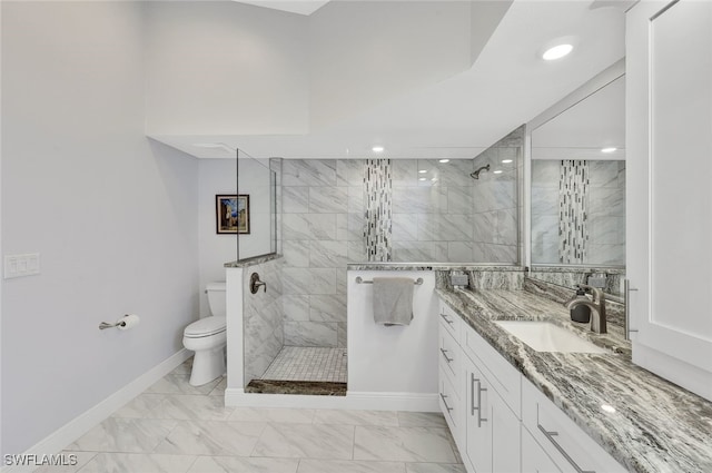 full bathroom with a walk in shower, toilet, vanity, baseboards, and marble finish floor