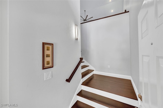 stairs with a ceiling fan, baseboards, and wood finished floors