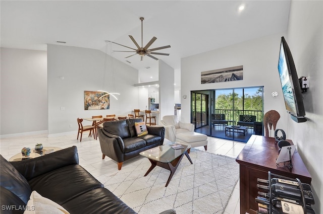 living area with high vaulted ceiling, visible vents, and ceiling fan